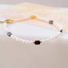 Handmade lucky bracelet made of Mother of pearl, hematite and gold-plated metal parts