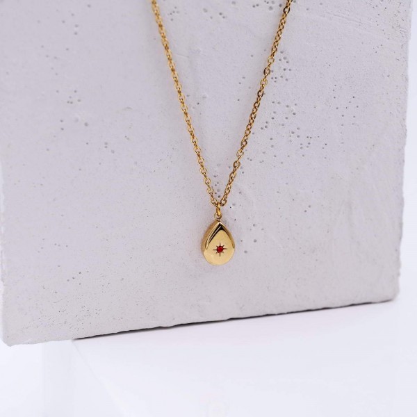 Short necklace of stainless steel with gold-plated metal parts